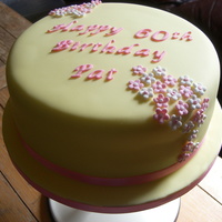 Spring Flower Birthday Cake This is a lemon cake, covered with yellow fondant and blossom flowers, perfect for a spring birthday
