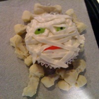 Halloween Mummy Cupcakes These are "blood velvet" halloween mummy cupcakes with SMBC frosting. The eyes are jelly beans and the mouth is a swedish fish....