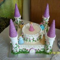 Princess Cake Done in Buttercream ,trim with royal icing hearts and towers covered in fondant.