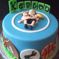 Sports Cake This was for my cousin's boys birthday. He wanted wrestling, football, basketball and BMX all in one cake so this is what I came up...