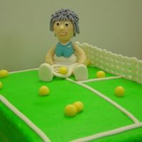 Time To Hang Up The Racket Old Timer!! Over the hill birthday for a tennis lover. Yellow cake covered in buttercream. Details and lady are made a gumpaste / fondant mixture.