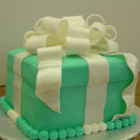 Gift Box My first fondant covered cake. The cake is a chocolate cake filled with butter cream and covered in fondant. The bow is made from a fondant...