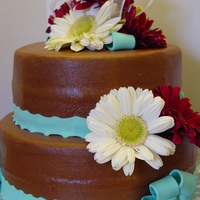 Wedding Shower My daughters wedding shower cake. It is chocolate cake covered and filled with chocolate buttercream. Fondant ribbon and fresh flowers.