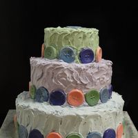 Cute As A Button This buttercream cake is as cute as a button! The buttons are edible and made from colored white chocolate. The bottom tier was vanilla...