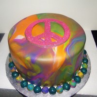 Peace Edible glitter peace sign made free-hand from fondant. I marbled the fondant to look like tie-dye.