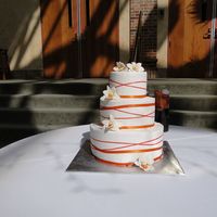 Orange Orchids Orange gumpaste orchids adorn this buttercream cake. The entire cake was marble vanilla bean and chocolate fudge with Bavarian cream...