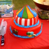 The Big Top Yellow cake covered in MMF with candy molds for the carnival themed figures. Top of tent sculpted out of rice krispy treats covered in MMF...