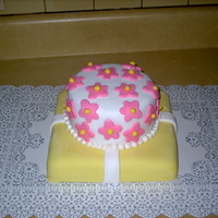 A Flower Filled Mother's Day Made this cake as a mother's day gift for all the moms in my husbands family. Covered both layers in fondant. Used a flower shaped...