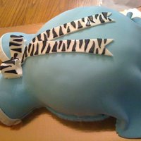 Belly Cake Belly baby shower cake. The mom to be was having a boy and wanted it to be blue with zebra. cake is yellow with butter cream filling