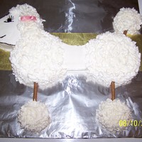 Poodle Yellow Cake w/ bc icing. Piroutte "chocolate fudge" wafers are the legs. bow is made out of fondant
