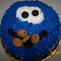Cookie Monster Yellow cake, pudding in the middle, bc icing, decorated with miniature oreo and chocolate chip cookies