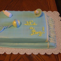 Baby Blanket Fondant covered butter cake with cream cheese frosting. Baby Rattle, pacifier and bottle made of gumpaste