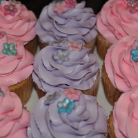 Girlie Cupcakes The client said she wanted pink and purple girlie cupcakes. The are vanilla with french vanilla buttercream and fondant flowers with luster...