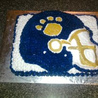 Football Helmet Cake I made this cake for a youth football team. The colors were royal blue, gold and white, decorated with buttercream.
