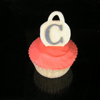 Cupcake With A 3-D Purse Purse is gumpaste with a MMF "C" that were both cut with my Cricut Cake. The red is buttercream.
