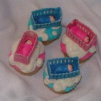 Babies In The Clouds Cupcakes with buttercream clouds, gumpaste cribs made with my Cricut Cake, and "mattress," blanket and baby made from MMF.