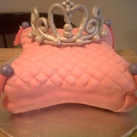 Adriana's Pillow Princess Cake Pillow cake, done with the wilton pans. covered in mmf with quilt pattern, gumpaste and fondant tassels. gumpaste crown. First time to make...