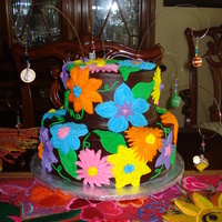 Fiesta/kitchen Themed Bridal Shower This is a chocolate cake with chocolate amaretto buttercream filling, and dark chocolate ganache covering it. The flowers were made from...