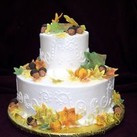 Two Tier Fall Theme Wedding Cake This was a small wedding cake with fondant leaves, pumpkins and acorns. I just love the fall colors. I hope I get to do a larger version of...