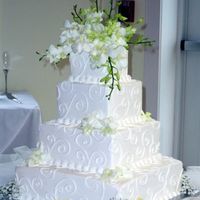 Square Wedding Cake With Orchids I guess the title says it all. This is a square cake iced in buttercream icing and decorated with fresh orchids. Thanks for looking.
