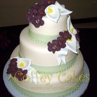 3 Tier Fondant Cake With Gumpaste Callas And Cosmos Fondant cake with fondant ribbon. Gumpaste callas and cosmos.Thanks for looking.