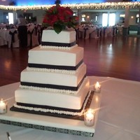 2Nd Wedding Cake Bride wanted a simple black and white cake. This is a 4 tier square cake with black satin ribbon on a cakestand(made by my husband) with a...