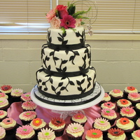 First Cake I was crazy enough to tackle a wedding cake for my first cake! Made as a gift for a friend. I used all MMF for cake and cupcake flowers....