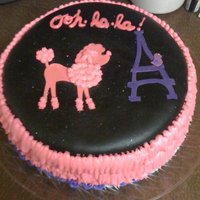 Pink And Black Poodle Cake poodle cake topped with fondant and wrapped in buttercream ruffles. cake has two layers, oreo and devils food