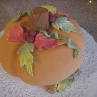 Carved Pumpkin Cake Cake is spiced pumpkin. butercream filling. fondant topping and decorations.