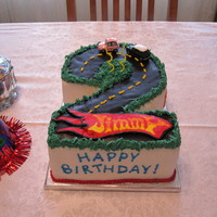 Second Birthday With Cars Carved 2 layer 9x13; covered with MMF and chocolate MMF, buttercream accents and FBCT hotwheels logo. Thanks to all the similar cakes here...