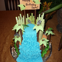 Safari Cake I made everything on this cake except the animals. The waterfall is royal icing. The bamboo and Palm trees are straws wrapped in gumpaste/...