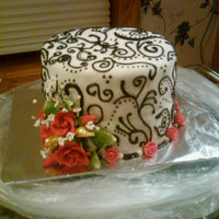 Wedding Cake 3 layer marble cake; first time with rolled mmf and piping. had trouble getting a seamless mmf but was able to cover it with the piping....