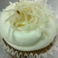 Carrot Cake Vegan carrot spice cake with pineapple buttercream. Topped with toasted coconut.