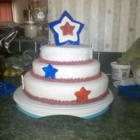 July 4Th Bottom tier is red velvet chocolate, middle tier is white cake, and top tier is blueberry cake. Covered in fondant with gumpaste accents...