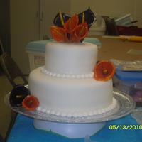 Orange And Purple Calla Lily Cake My first doubled tiered cake. The calla lilies are fondant and gum paste mixture and then painted.
