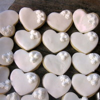 Engagement Favors white heart cookies covered in fondant and brushed with pearl luster dust.