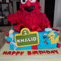 Elmo 10-inch cake with Elmo made from RKT and piped with RI (Wilton grass tip). Cookie Monster, Big Bird, Oscar and accents are made from...