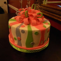 Ribbons And Bows A 2 layer white cake iced in buttercream with fondant accents and a fondant bow.