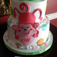 It's A Girl! A 2 tiered buttercream cake decorated with fondant accents to match a napkin.