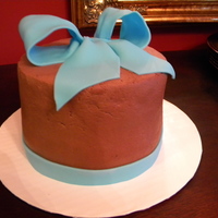 Happy Birthday! A 2 layer chocolate cake with chocolate ganache' (sp?) between the layers and iced in chocolate buttercream! The blue bow was make of...