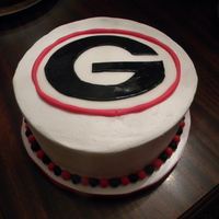 Georgia Bulldog Cake 2 layer chocolate cake iced in buttercream with the Georgia Bulldog emblem on top made of fondant.