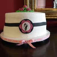 Simple And Elegant A 2 layer yellow cake iced in buttercream. Fondant and buttercream decorations were added.