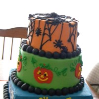 Halloween Party Cake! 3 tiered stacked cake with buttercream icing and fondant decorations.