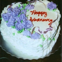 Happy Anniversary Chocolate and vanilla Ice cream cake iced with whipped topping and whipped topping flowers.