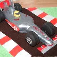 Lewis Hamilton's Mclaren F1 Car Vanilla sponge carved and decorated with fondant.
