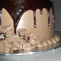 Chocolate Heaven Chocolate cake, chocolate buttercream with dark chocolate ganache. Chocolate buttercream flowers with pink dragee accents.