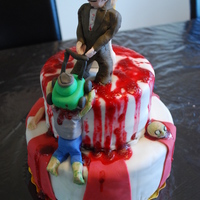 Zombie Fighting Bride & Groom Cake Client requested a two tiered Halloween cake with a bride and groom fighting off zombies.