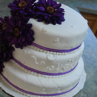 Wedding Cake All vanilla 3 tiered wedding cake with purple daisies.