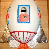 Spaceship Birthday Cake (Rocket) This was the cake I made for my son's third birthday! We had an outer space theme. I had his picture on it in his astronaut Halloween...