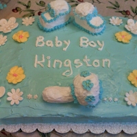 My First Baby Shower Cake vanilla cake with whipped icing, shoes and radder are from cereal treats